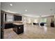 Bright, open-concept with kitchen island, tile flooring, and sliding doors to the lanai at 20945 Oldenburg Loop, Mount Dora, FL 32757