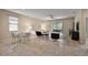 Bright living room with sliding doors to the outside, neutral walls, and tile floors at 20945 Oldenburg Loop, Mount Dora, FL 32757