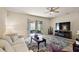 Bright living room with sliding doors to the outside, neutral walls, and engineered wood floors at 20945 Oldenburg Loop, Mount Dora, FL 32757