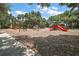 Community playground features multiple slides and play structures with a wood chip ground cover at 20945 Oldenburg Loop, Mount Dora, FL 32757