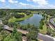 Scenic aerial view of community pond, wooden bridge, lush green landscape, and walking trails at 20945 Oldenburg Loop, Mount Dora, FL 32757