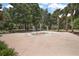 A splash pad with a colorful design and playful fountains surrounded by green trees and open space at 20945 Oldenburg Loop, Mount Dora, FL 32757