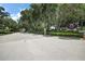 Landscaped entrance to Sullivan Ranch features mature trees and an elegant community sign at 20945 Oldenburg Loop, Mount Dora, FL 32757