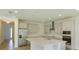 Bright kitchen with stainless steel appliances, quartz countertops, and a large island at 2208 Keystone Pass Blvd, Minneola, FL 34715