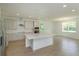 Open kitchen featuring a large center island, stainless appliances, and tile floors at 2208 Keystone Pass Blvd, Minneola, FL 34715