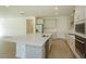 Open kitchen with stainless steel appliances, large island, and tile floors at 2208 Keystone Pass Blvd, Minneola, FL 34715