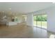 Open concept kitchen and living area with modern tile floors and sliding glass doors at 2208 Keystone Pass Blvd, Minneola, FL 34715