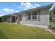 Exterior view of a home with a screened in porch and green grass at 2265 Hackney Way, The Villages, FL 32162