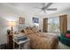 Bedroom with ceiling fan, two windows, and a small desk with printer at 2265 Hackney Way, The Villages, FL 32162