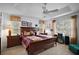 Comfortable bedroom features a tray ceiling with fan and large windows at 2265 Hackney Way, The Villages, FL 32162
