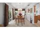 Inviting dining area featuring a tray ceiling, sliding glass doors, and elegant decor for a comfortable dining experience at 2265 Hackney Way, The Villages, FL 32162