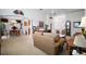Open-concept living room flowing into the dining area with neutral walls and flooring creating a bright and airy atmosphere at 2265 Hackney Way, The Villages, FL 32162