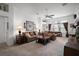 Comfortable living room with a ceiling fan, plush sofas, and large windows providing natural light and a relaxing atmosphere at 2265 Hackney Way, The Villages, FL 32162
