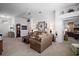 Inviting living room featuring neutral carpet, ceiling fan, and comfortable sofas creating a cozy and bright space at 2265 Hackney Way, The Villages, FL 32162