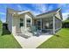 Well-kept backyard with patio featuring lounge chairs, complemented by a screened-in porch for outdoor enjoyment at 2369 Unity Ter, The Villages, FL 32162