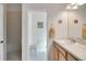 Bathroom featuring a walk-in shower, white sink, and decorations at 2369 Unity Ter, The Villages, FL 32162
