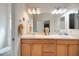 Bathroom featuring double sinks, white countertops, and light wood cabinetry at 2369 Unity Ter, The Villages, FL 32162