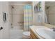 Cozy bathroom features shower with bathtub and sleek sink at 2369 Unity Ter, The Villages, FL 32162