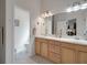 Bright bathroom featuring double sinks, vanity with storage, and separate toilet room at 2369 Unity Ter, The Villages, FL 32162