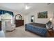 Bedroom featuring a window, a dresser, a painting, and a large bed at 2369 Unity Ter, The Villages, FL 32162