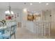 Dining room featuring a glass table and views of the kitchen at 2369 Unity Ter, The Villages, FL 32162