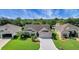 Charming single-story home featuring a well-manicured lawn, tasteful landscaping, and a two-car garage at 2369 Unity Ter, The Villages, FL 32162