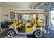 Garage with a golf cart, gray flooring, and rolling door at 2369 Unity Ter, The Villages, FL 32162