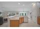 Open concept kitchen featuring white appliances and natural light at 2369 Unity Ter, The Villages, FL 32162