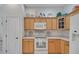 Bright kitchen features wooden cabinetry, white appliances, and lovely decorative details at 2369 Unity Ter, The Villages, FL 32162