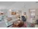 Spacious living room with tile floors that opens to the kitchen at 2369 Unity Ter, The Villages, FL 32162