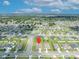 Aerial view with a location pin indicating the property's position in the neighborhood, under a bright sky at 2488 Begonia St, Mascotte, FL 34753