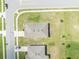 Aerial view showing a home's roof, driveway, and surrounding green lawn space at 2488 Begonia St, Mascotte, FL 34753