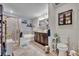 Bathroom featuring a shower, soaking tub, double vanity, and decorative shelving at 2488 Begonia St, Mascotte, FL 34753