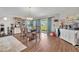 Cozy dining area with a table set for six, views of the backyard, and stylish decor at 2488 Begonia St, Mascotte, FL 34753