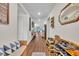 Inviting hallway with wood floors and decorative wall accents, leading to the main living areas at 2488 Begonia St, Mascotte, FL 34753