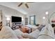 Comfortable living room with a large TV, cozy seating, and stylish decor at 2488 Begonia St, Mascotte, FL 34753