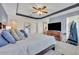 Main bedroom featuring a large bed, tray ceiling and wood dresser and TV at 2488 Begonia St, Mascotte, FL 34753