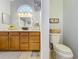 A bathroom featuring tile flooring, ample vanity cabinet space, and is well-lit from both overhead and natural light at 26338 Glen Eagle, Leesburg, FL 34748
