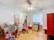 A cozy bedroom with natural light, ceiling fan, and laminate wood flooring, ready for personal touches at 26338 Glen Eagle, Leesburg, FL 34748