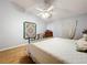 Bedroom showcasing vaulted ceiling, ceiling fan, and laminate wood flooring in this comfortable and stylish space at 26338 Glen Eagle, Leesburg, FL 34748