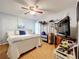 Well-lit bedroom featuring hardwood floors and ceiling fan at 26338 Glen Eagle, Leesburg, FL 34748