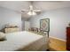 Bright bedroom featuring laminate floors, a ceiling fan, and ample natural light creating a cozy retreat at 26338 Glen Eagle, Leesburg, FL 34748