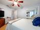 This bedroom features a ceiling fan and a mirrored closet, offering both comfort and functionality at 26338 Glen Eagle, Leesburg, FL 34748