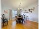 Cozy dining room with wood-look flooring, chandelier and a collection of framed pictures on the wall at 26338 Glen Eagle, Leesburg, FL 34748