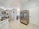 Bright kitchen featuring stainless steel refrigerator and appliances and view into living space at 26338 Glen Eagle, Leesburg, FL 34748