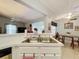 Open kitchen with stainless steel sink, white cabinets and view of the dining and living areas at 26338 Glen Eagle, Leesburg, FL 34748