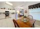 Bright kitchen view showing white cabinets, stainless steel appliances, and seamless flow into the living area at 26338 Glen Eagle, Leesburg, FL 34748