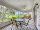 Relaxing screened patio features a ceiling fan, outdoor furniture, and a patterned floor, perfect for entertaining at 26338 Glen Eagle, Leesburg, FL 34748