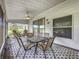 This screened patio with ceiling fan features patterned floors and outdoor furniture, perfect for enjoying the outdoors at 26338 Glen Eagle, Leesburg, FL 34748