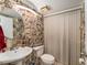 Powder room featuring a toilet, sink, and wall decorations at 2920 Poplar Ave, Leesburg, FL 34748
